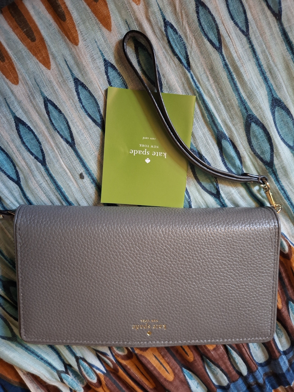 kate spade gray pebbled leather wristlet clutch with gold-tone logo